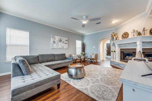 living room with ceiling fan, crown molding, and dark hardwood / wood-style floors