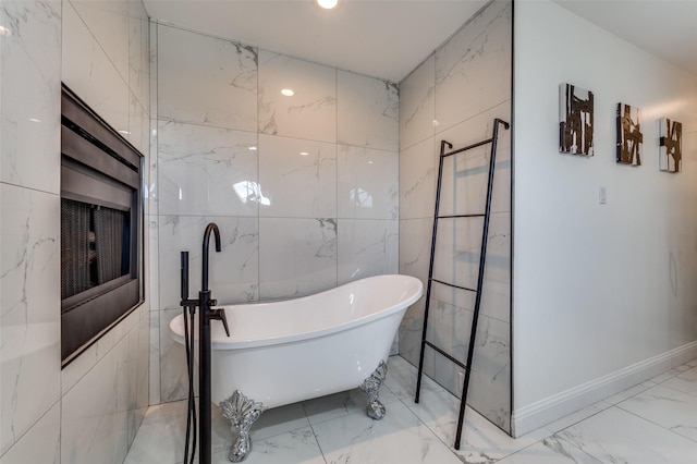 bathroom with tile walls and a tub to relax in