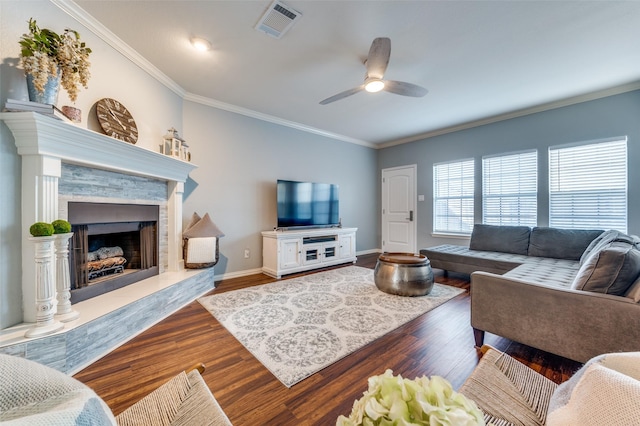 living room featuring a premium fireplace, ceiling fan, crown molding, and dark hardwood / wood-style flooring