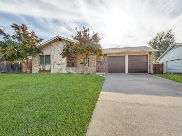 single story home with a garage and a front lawn