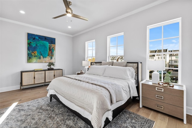 bedroom with ceiling fan, light hardwood / wood-style floors, and ornamental molding