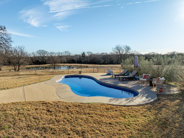 view of pool with a patio area and a lawn