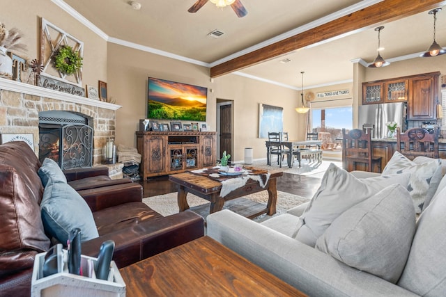 living room with ceiling fan, ornamental molding, a fireplace, and wood-type flooring