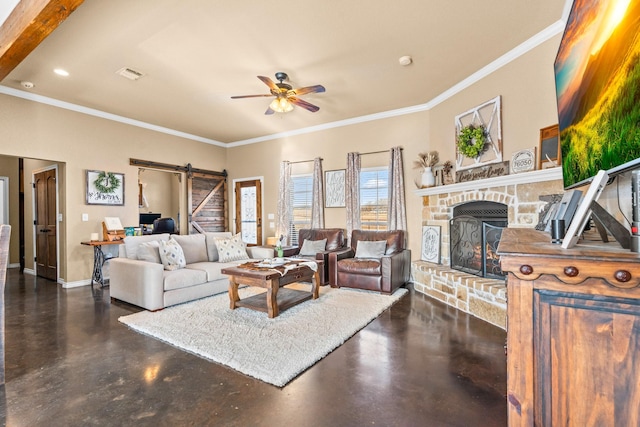 living room with a fireplace, ornamental molding, ceiling fan, and a barn door