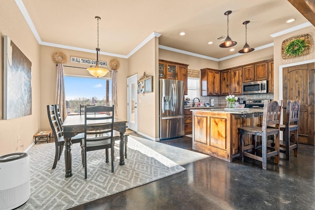 kitchen featuring stainless steel appliances, decorative light fixtures, a center island, decorative backsplash, and a breakfast bar