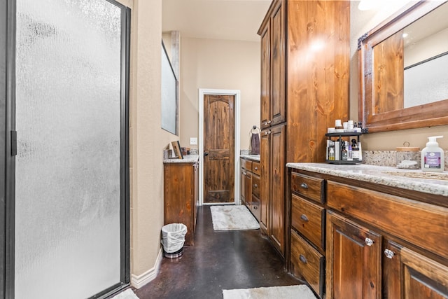 bathroom with a shower with door and vanity