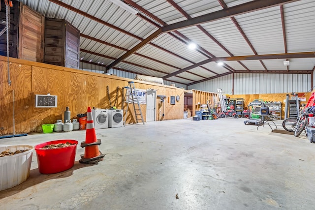 garage featuring separate washer and dryer and wood walls