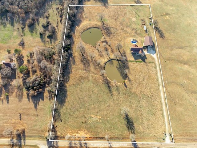 birds eye view of property with a rural view and a water view