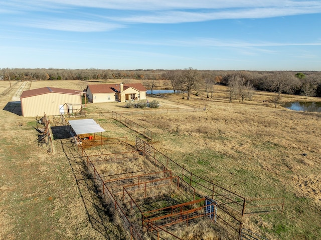 birds eye view of property featuring a rural view and a water view