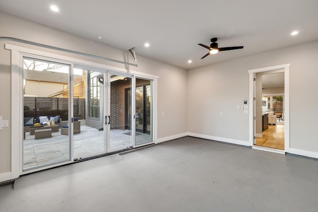 interior space with concrete floors and ceiling fan