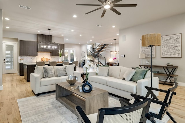 living room featuring light hardwood / wood-style floors and ceiling fan