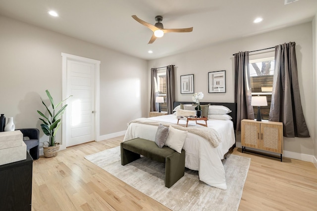 bedroom with light hardwood / wood-style floors and ceiling fan