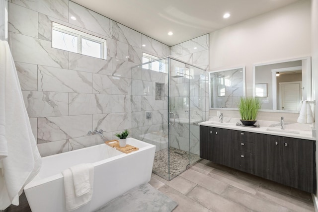 bathroom with vanity and separate shower and tub