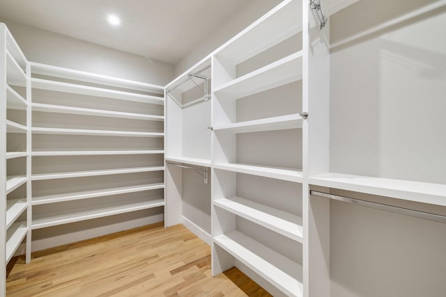 walk in closet with hardwood / wood-style floors