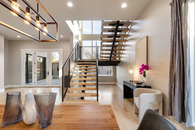 stairway featuring wood-type flooring and french doors