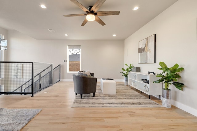 sitting room featuring ceiling fan and light wood-type flooring