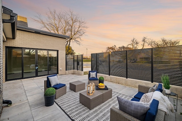 patio terrace at dusk featuring outdoor lounge area