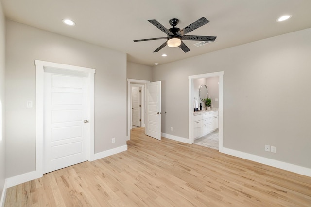 unfurnished bedroom featuring connected bathroom and light hardwood / wood-style floors