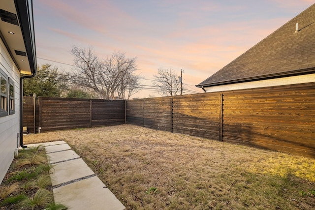 view of yard at dusk