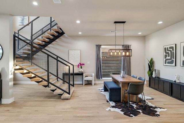 dining area featuring an inviting chandelier and light wood-type flooring