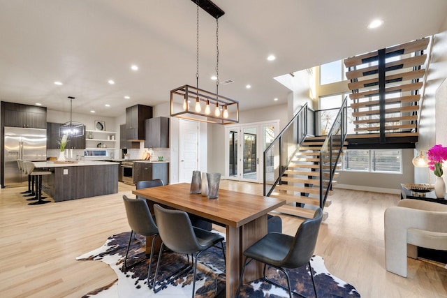 dining space featuring light hardwood / wood-style flooring and french doors