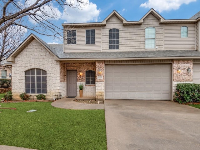 view of front of home featuring a garage and a front yard