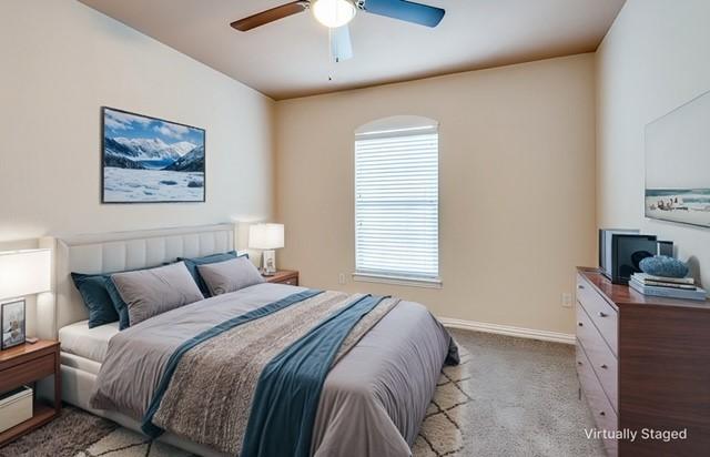 carpeted bedroom featuring ceiling fan