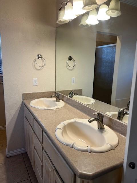 bathroom featuring tile patterned flooring and vanity