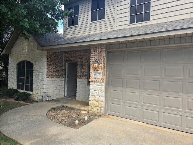 doorway to property with a garage