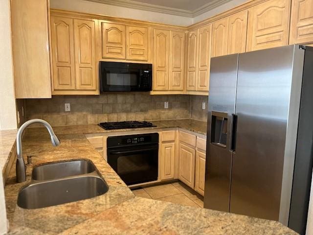 kitchen featuring light brown cabinetry, black appliances, light tile patterned floors, and sink