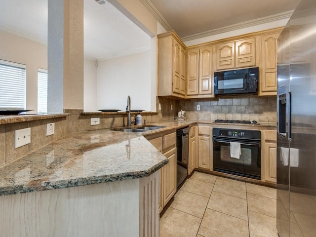 kitchen featuring sink, black appliances, kitchen peninsula, and light brown cabinets