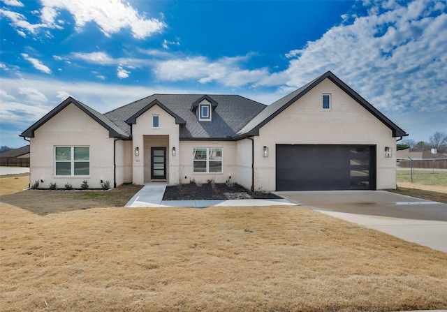 view of front facade featuring a front lawn and a garage