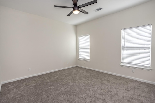 empty room with ceiling fan and carpet flooring