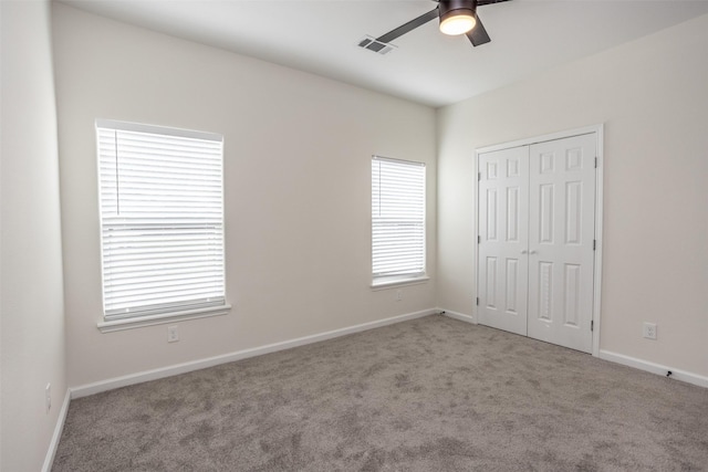 unfurnished bedroom with ceiling fan, a closet, and light colored carpet