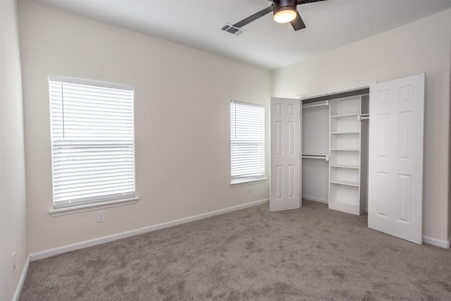 unfurnished bedroom with ceiling fan, a closet, and carpet flooring