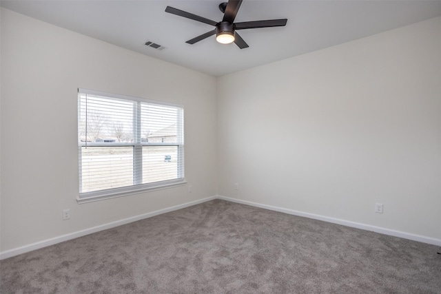 carpeted spare room featuring ceiling fan