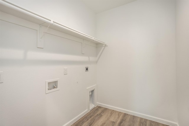 clothes washing area featuring hookup for a washing machine, hardwood / wood-style floors, electric dryer hookup, and hookup for a gas dryer