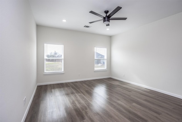 unfurnished room with ceiling fan and dark hardwood / wood-style flooring