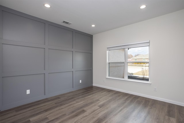 unfurnished room with wood-type flooring