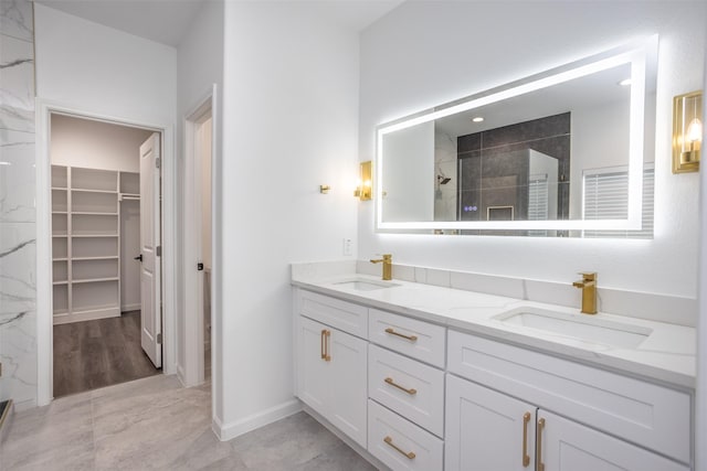 bathroom featuring a tile shower and vanity