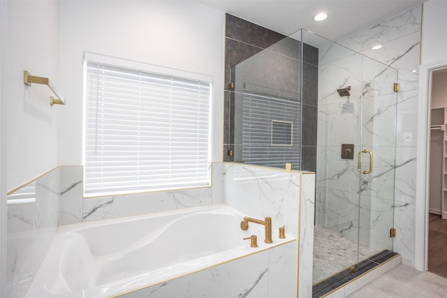 bathroom with separate shower and tub