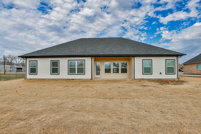 rear view of property with a lawn