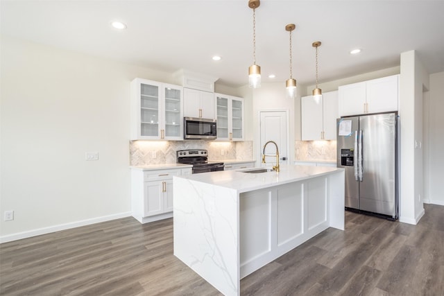 kitchen with white cabinetry, appliances with stainless steel finishes, a center island with sink, and sink