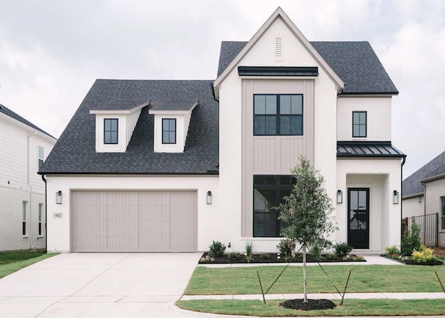 modern inspired farmhouse with a front lawn and a garage