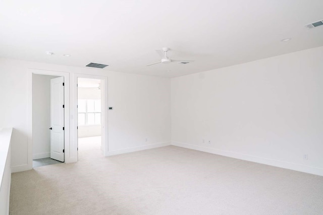 unfurnished room with ceiling fan and light carpet