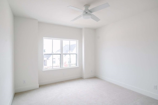 unfurnished room featuring ceiling fan and light carpet