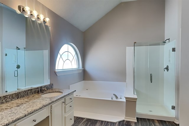 bathroom with lofted ceiling, wood-type flooring, vanity, and plus walk in shower