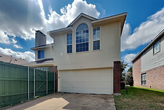 rear view of property featuring central AC unit, a lawn, and a garage