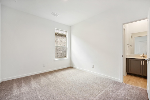 carpeted empty room with sink