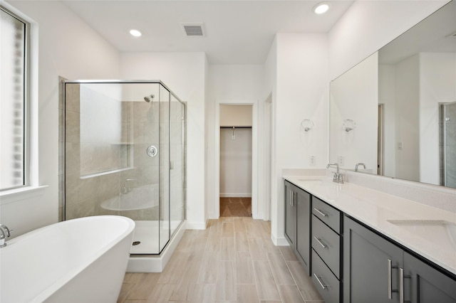 bathroom with vanity and plus walk in shower